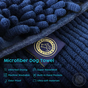 A close-up view of the product tag on a Pickle & Polly Microfiber Pet Towel. The text reads, "Microfiber Dog Mat. Ultra-Fast Drying, Super Absorbent, Machine Washable, Non-Slip Backing, Odor Proof, Ultra-Soft Materials."