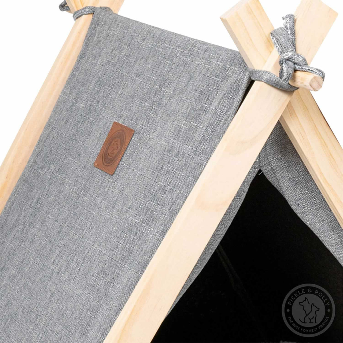 A close-up of the leather seal of quality on a Pickle & Polly Pet Tent (Gray).
