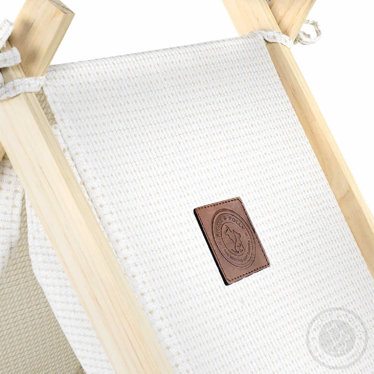 A close-up of the leather seal of quality on a Pickle & Polly Pet Tent (White).